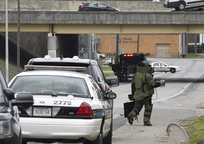 Suited up in protective gear, a Chattanooga bomb squad member responds to a suspicious package call on E. 25th Street, near S. Hickory Street, Wednesday afternoon.