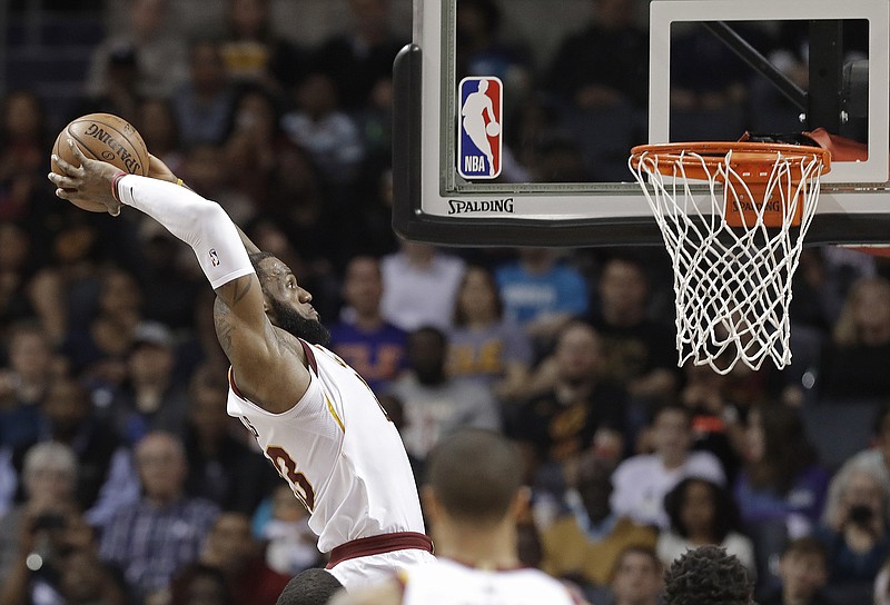 Cleveland Cavaliers' LeBron James goes up to dunk against the Charlotte Hornets during the first half of an NBA basketball game in Charlotte, N.C., Wednesday, March 28, 2018. (AP Photo/Chuck Burton)