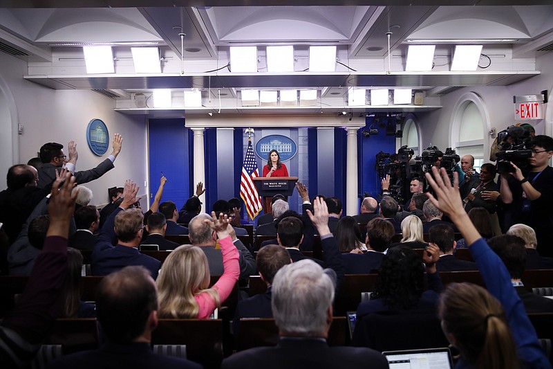 Reporters raise their hands to ask a question of White House press secretary Sarah Huckabee Sanders during the daily press briefing at the White House, Wednesday, March 28, 2018, in Washington. (AP Photo/Alex Brandon)