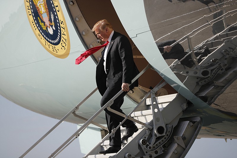 President Donald Trump walks down the stairs of Air Force One during his arrival at Palm Beach International Airport, in West Palm Beach, Fla.,Thursday, March 29, 2018. Trump is spending the weekend at his his Mar-a-Lago estate. (AP Photo/Pablo Martinez Monsivais)