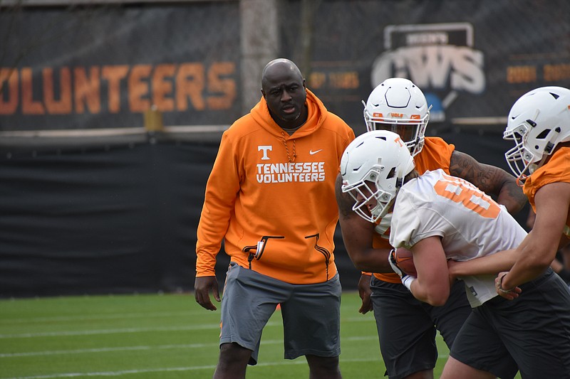 Tennessee co-defensive coordinator and outside linebackers coach Chris Rumph oversees a drill during a recent practice at Haslam Field.