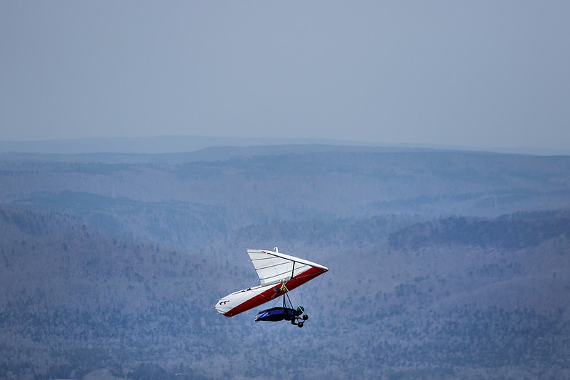 A hang glider flies over Lookout Valley seen from Lookout Mountain Hang Gliding on Friday, March 16, 2018, in Rising Fawn, Ga. Chattanooga has grown to be one of the most popular hang-gliding destinations in the country.