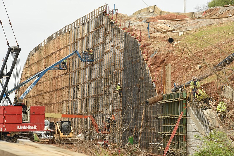 Construction steel workers weld and secure rebar framing Tuesday, March 27, 2018, on the massive wall designed to hold Cameron Hill in place above U.S. Highway 27 in downtown Chattanooga.