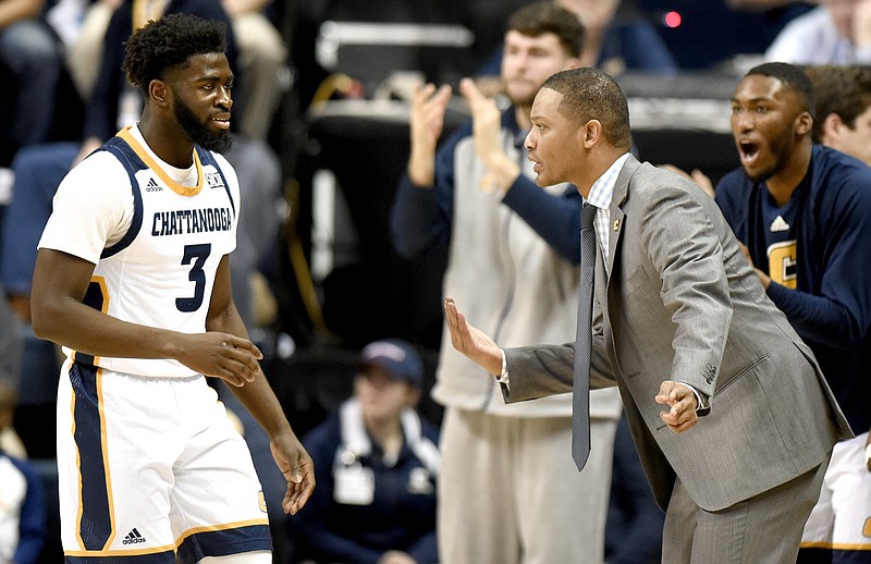 UTC head coach Lamont Paris instructs David Jean-Baptiste (3).  The Wofford Terriers visited the Chattanooga Mocs in Southern Conference basketball action at McKenzie Arena on February 17, 2018.  