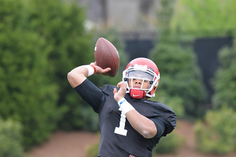 Freshman quarterback Justin Fields throws a pass during a Georgia practice this past week in Athens.