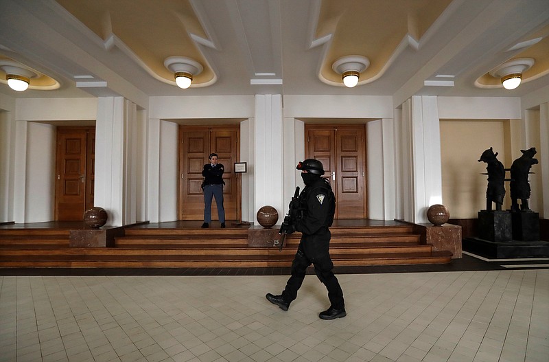 FILE - In this Friday, Nov. 24, 2017 file photo, a prison guard walks outside a courtroom during an appeal by Yevgeniy Nikulin from Russia who faces charges of hacking computers of American companies, in Prague, Czech Republic.