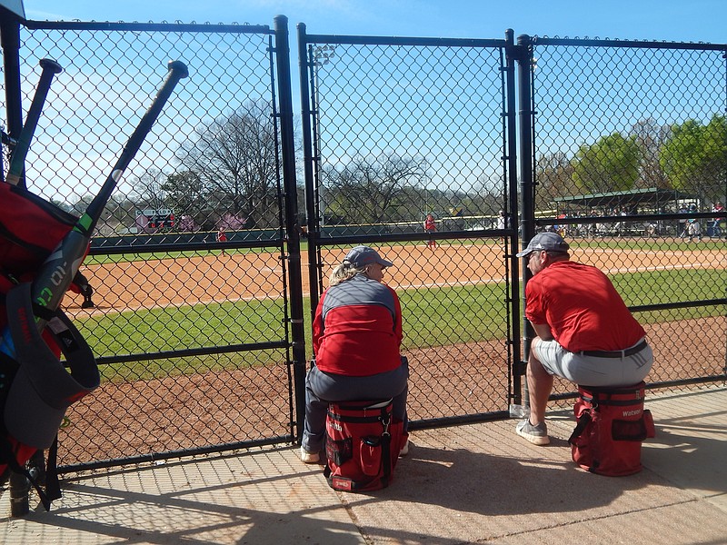 Baylor head softball coach Kelli Smith, left, talks defensive strategy with assistant Tom Watson during the Gold championship game in Soddy-Daisy's Lady Trojan Invitational at Warner Park.