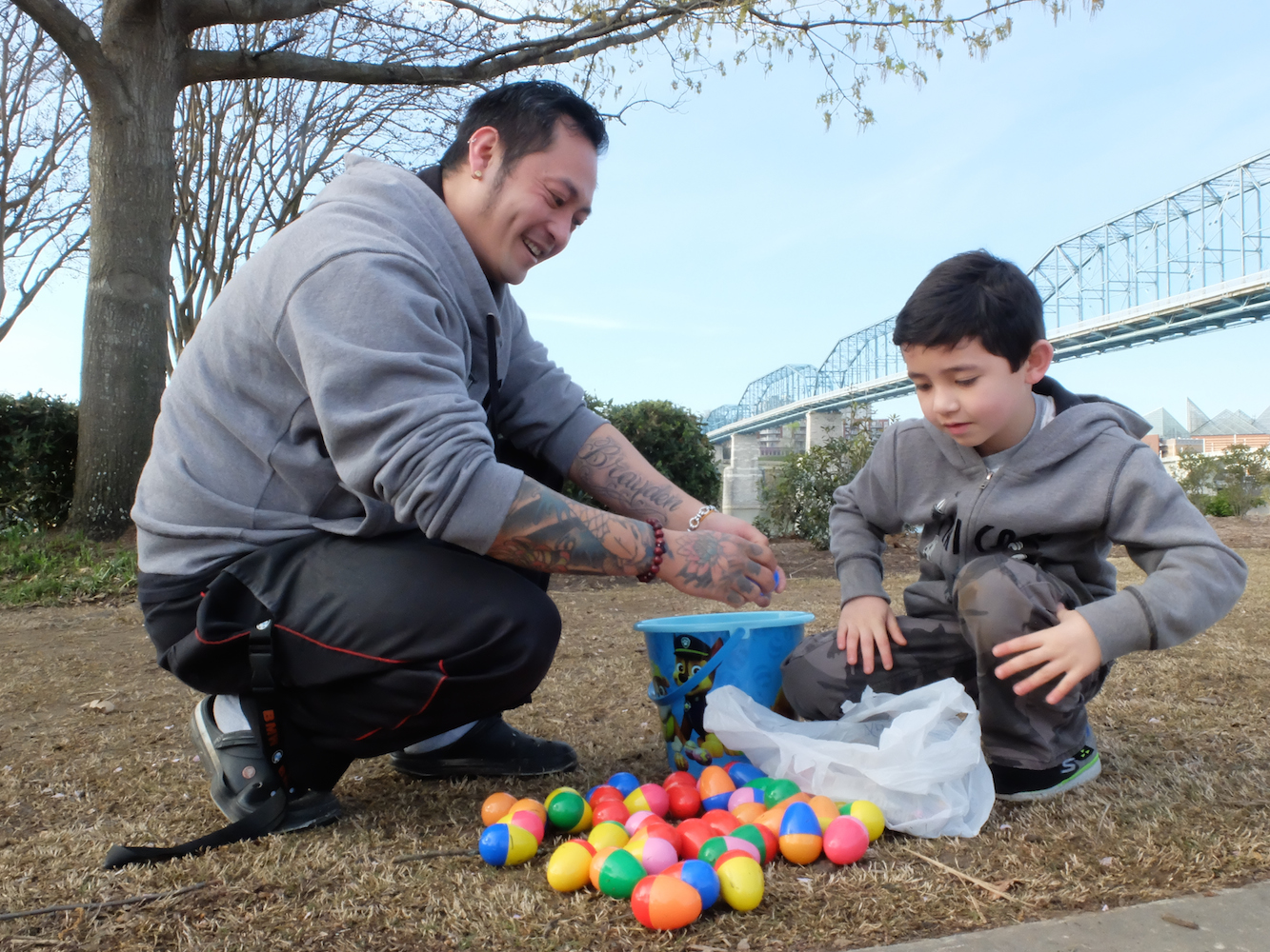 Cracking Open the Eggs -- Brayden Tjahyadi, right, 7, and his dad, Eddy Tjahyadi, remove the contents of each egg following the Easter at Coolidge egg hunt Sunday morning. The event, sponsored by Stuart Height Baptist Church, is in its 10th year.