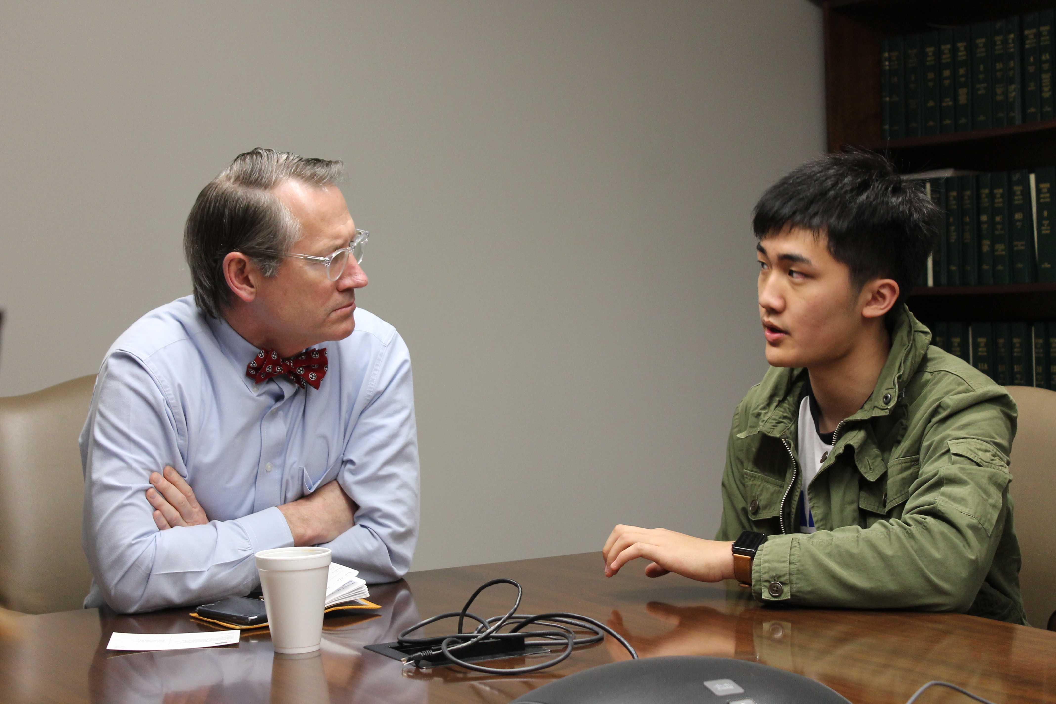 State Senator Bo Watson listens to Allen Liu, a senior at the McCallie School, as Liu talks about red flag laws — laws that allow law enforcement to temporarily remove weapons from a person who is deemed a threat to themselves or others — when the group of students met with lawmakers in Nashville on Monday, April 2.