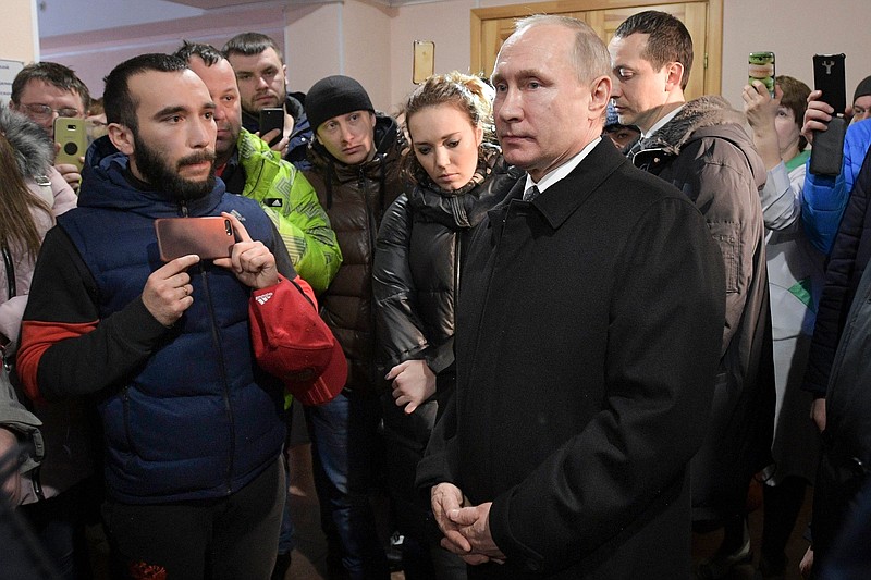 
              FILE - In this file photo taken on Tuesday, March 27, 2018, Russian President Vladimir Putin, center, listens to locals and relatives of the victims of a fire in a multi-storey shopping center in the Siberian city of Kemerovo, about 3,000 kilometers (1,900 miles) east of Moscow, Russia. The deaths of over 50 people in the March 25, 2018, fire has torment their loved ones and left questions about the state of Russia. (Alexei Druzhinin, Sputnik, Kremlin Pool Photo via AP, File)
            