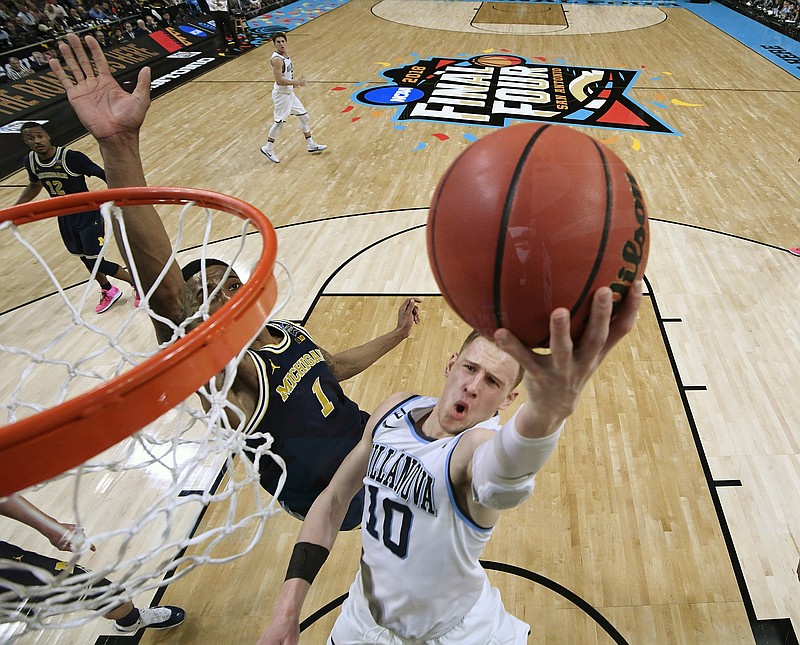 Villanova's Donte DiVincenzo (10) goes up for a shot past Michigan's Charles Matthews (1) during the second half in the championship game of the Final Four NCAA college basketball tournament, Monday, April 2, 2018, in San Antonio. (AP Photo/Chris Steppig, NCAA Photos Pool)