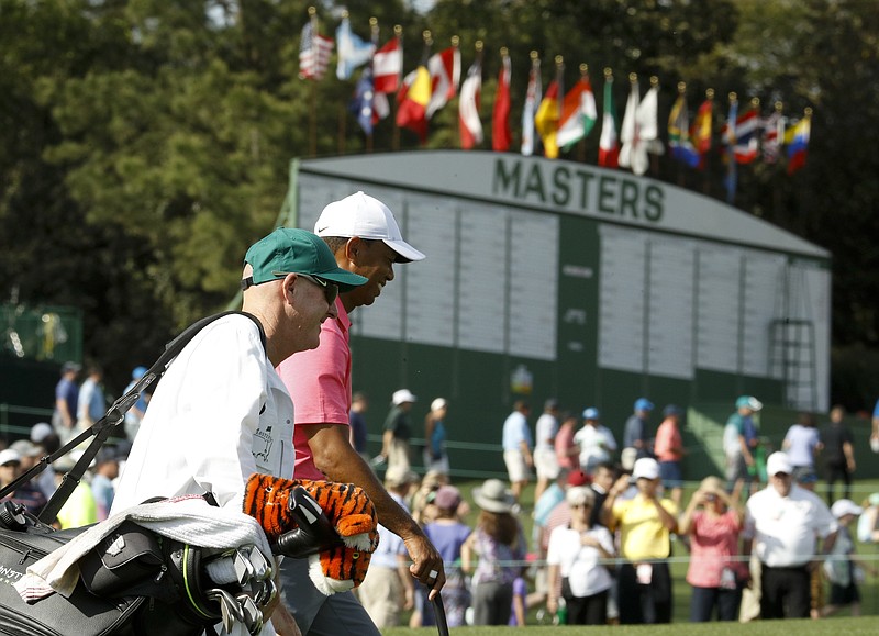 Tiger Woods, right, and caddie, Joe LaCava walk to the ninth green during practice for the Masters golf tournament at Augusta National Golf Club, Monday, April 2, 2018, in Augusta, Ga. (AP Photo/Charlie Riedel)
