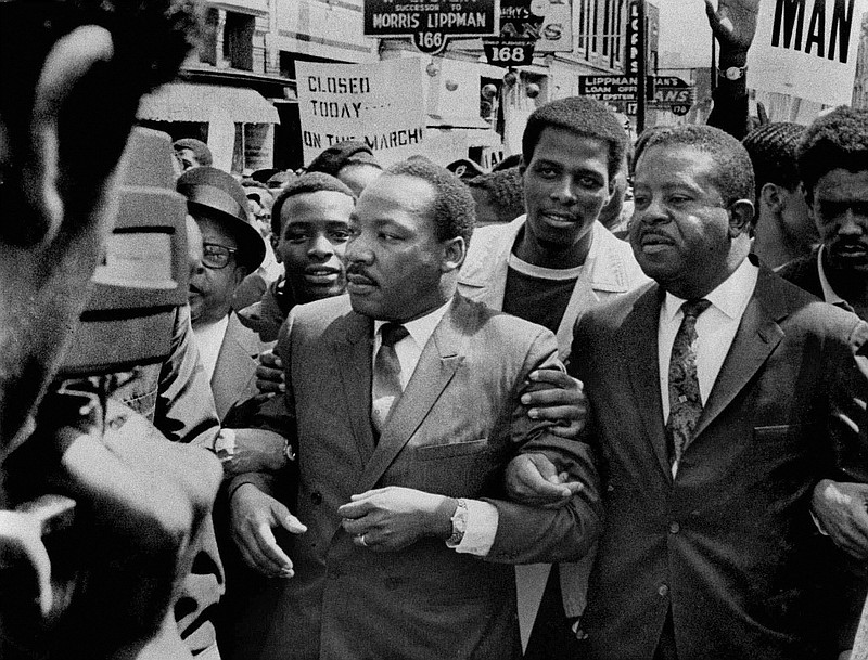 Dr. Martin Luther King Jr., left, marches on behalf of striking Memphis sanitation workers on March 28, 1968. A week later, he would be assassinated on the balcony of a Memphis motel.