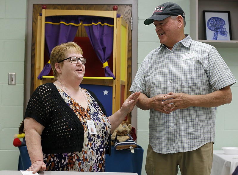 Assistant Director of Supported Living Patti Wade, left, and Jack Goodlet share stories about Jack's brother John during an open house at the Orange Grove Center on Tuesday, April 3, 2018 in Chattanooga, Tenn.