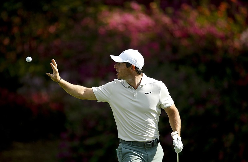 Rory McIlroy, of Northern Ireland, catches a ball from his caddie on the 13th hole during practice for the Masters golf tournament at Augusta National Golf Club, Tuesday, April 3, 2018, in Augusta, Ga. (AP Photo/Charlie Riedel)