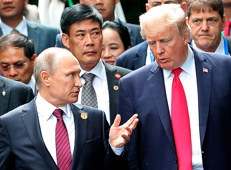 In this Nov. 11, 2017, file photo, President Donald Trump, right, and Russia President Vladimir Putin talk during the family photo session at the APEC Summit in Danang. The Trump administration is opening the door to a potential White House meeting between Trump and Putin. It would be the first time Putin has been at the White House in more than a decade and come at a time of rising tensions between the two global powers. (Mikhail Klimentyev, Sputnik, Kremlin Pool Photo via AP)