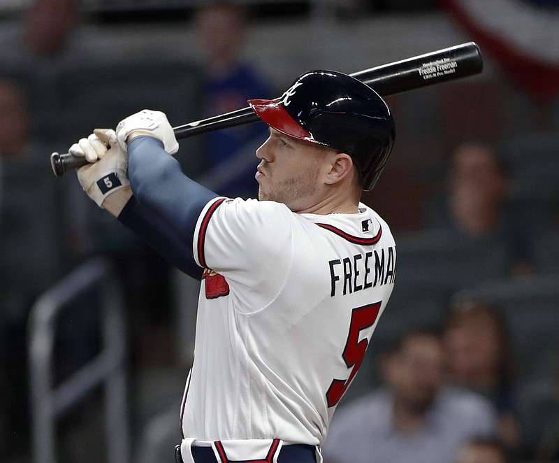 Atlanta Braves' Freddie Freeman (5) follows through on a three-run home run in the second inning of a baseball game against the Washington Nationals on Tuesday, April 3, 2018, in Atlanta. (AP Photo/John Bazemore)