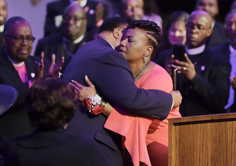 Martin Luther King III hugs his sister, the Rev. Bernice King, after she spoke at the Mason Temple of the Church of God in Christ in Memphis, Tenn., Tuesday, April 3, 2018. The church is where their father, the Rev. Martin Luther King Jr., delivered his final speech on April 3, 1968, the night before he was assassinated. (AP Photo/Mark Humphrey)