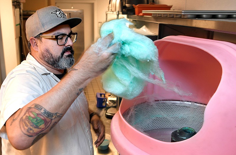 Nashville's Gray & Dudley executive chef Levon Wallace demonstrates how his restaurant makes cotton candy, which is served after every meal, a tradition for 21c museum hotels. The cotton candy is served in a glass to customers after meals. (Photo: Shelley Mays/The Tennessean )