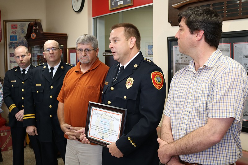 Captain Robert Thompson, Captain David Tallent, Van Anderson, Fire Chief Phil Hyman and Peter Baldschun, husband of the deceased driver and father of the child saved by Mr. Anderson.
