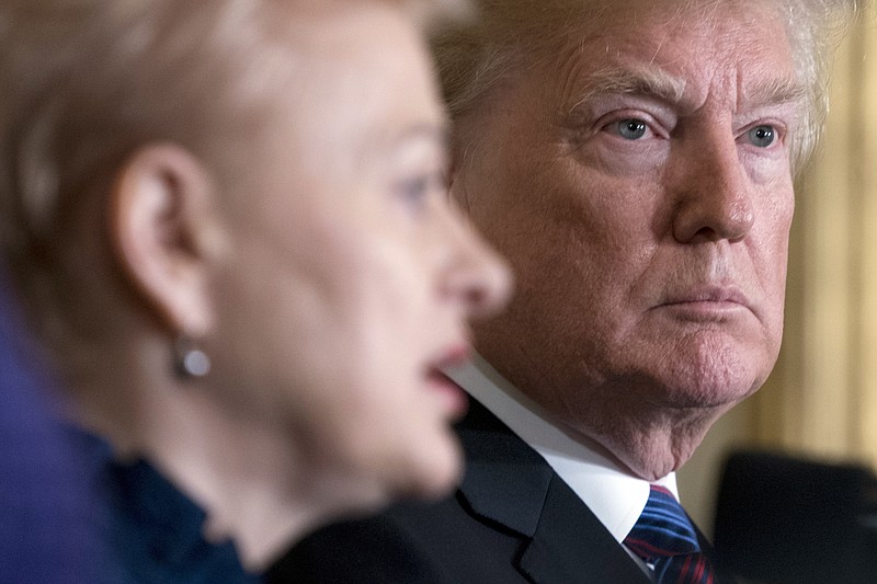 President Donald Trump listens as Lithuanian President Dalia Grybauskaite, left, speaks at a news conference in the East Room of the White House in Washington, Tuesday, April 3, 2018. (AP Photo/Andrew Harnik)