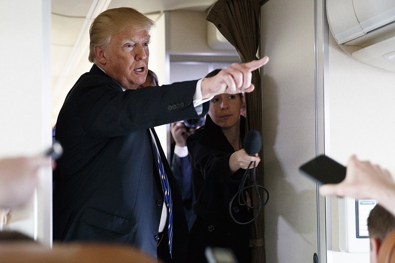 
              President Donald Trump talks with reporters aboard Air Force One, Thursday, April 5, 2018. (AP Photo/Evan Vucci)
            