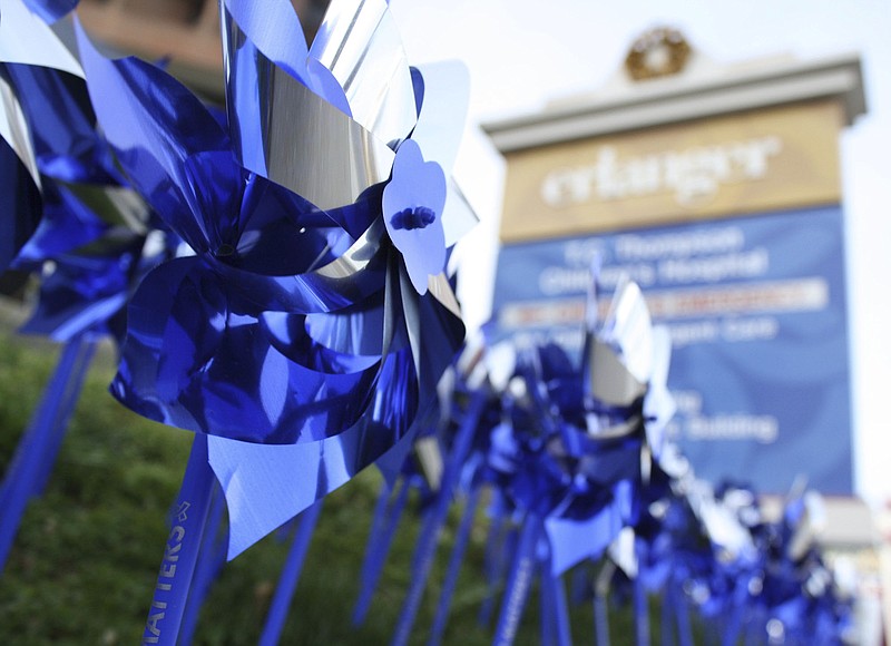 Pinwheels placed in front of the Children's Hospital at Erlanger entrance spin in the breeze on Wednesday, April 4, 2018. They represent the 391 children treated for child abuse at the hospital in 2017.