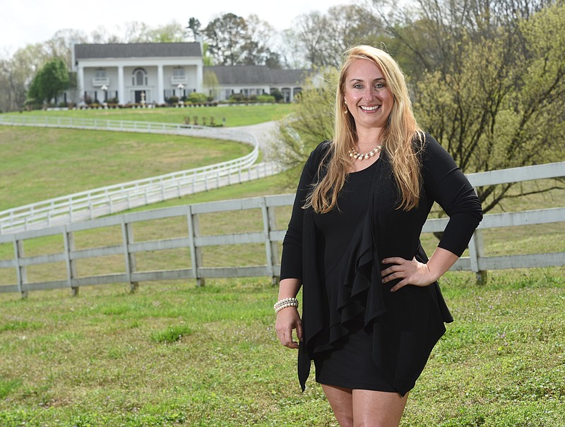 Tara Plumlee stands in front of the 21,000 square-foot Bell Mill Mansion in Ooltewah. It is one of her four venues in the Chattanooga area.