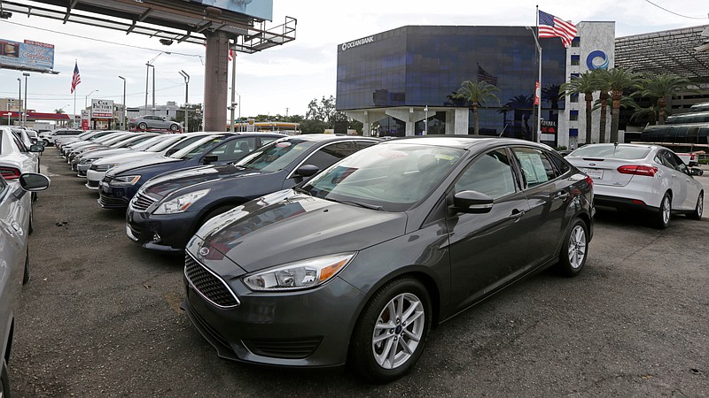 FILE- In this Jan. 17, 2017, file photo, certified pre-owned vehicles sit on display at an auto dealership in Miami. Used vehicle sales hit 39.2 million vehicles in 2017, more than double the number of new automobiles sold, according to the Edmunds.com auto website. (AP Photo/Alan Diaz, File)