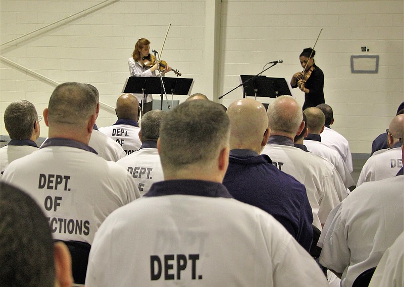 Holly Mulcahy, left, and Mary Corbett perform in front of 128 Walker State Prison's Faith and Character Based inmates.