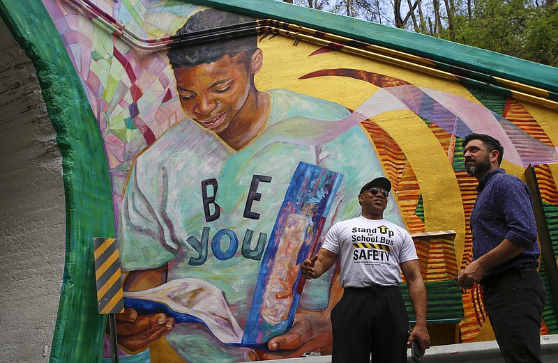 Chattanooga Christian School teacher Shaun LaRose, right, and Dank Hawkins, the facility manager at Eastdale Recreation Center, take in the sight of a new mural at the east end of the Wilcox Tunnel.