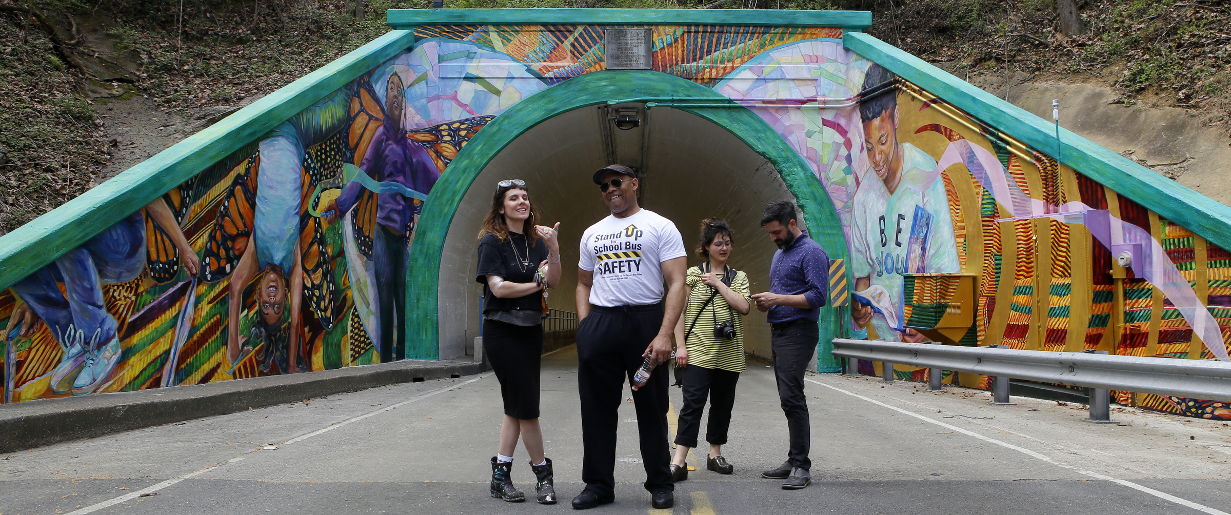 Greta McLain, Dank Hawkins, Samie Johnson and Shaun LaRose chat about the mural project at the east end of the Wilcox Tunnel. McLain, founder of GoodSpace Murals in Minneapolis, is the lead artist on the project. Hawkins is the facility manager at Eastdale Youth and Family Development Center. Johnson is an artist on the GoodSpace team. LaRose is a teacher at Chattanooga Christian School.