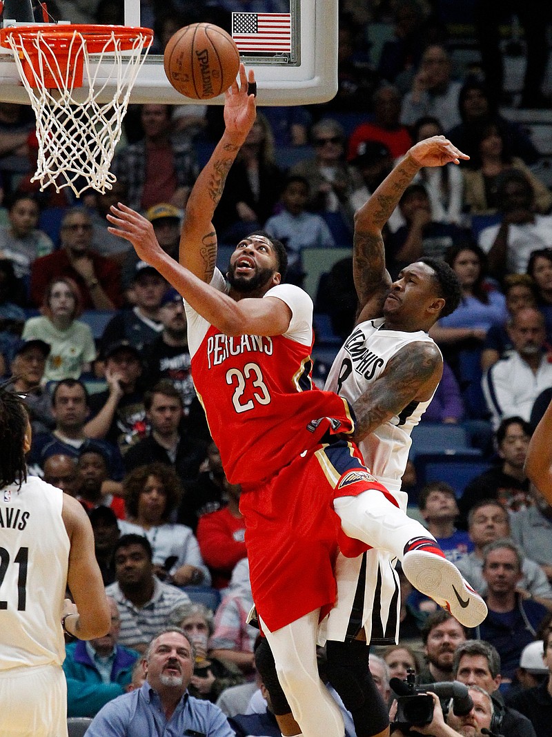 New Orleans Pelicans forward Anthony Davis (23) is fouled by Memphis Grizzlies guard MarShon Brooks (8) during the first half of an NBA basketball game in New Orleans, Wednesday, April 4, 2018. (AP Photo/Scott Threlkeld)