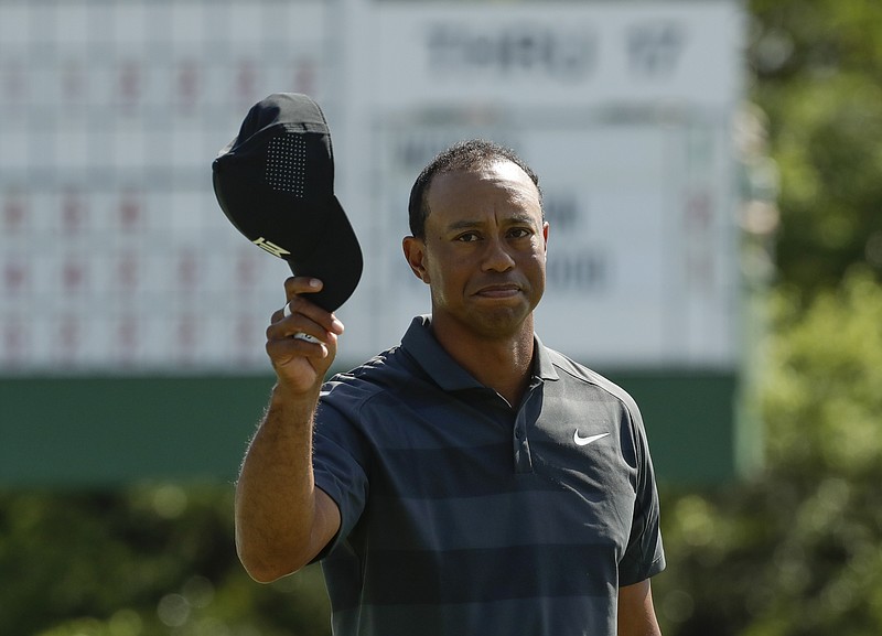 Tiger Woods tips his hat on the 18th hole during the first round at the Masters golf tournament Thursday, April 5, 2018, in Augusta, Ga. (AP Photo/Chris Carlson)