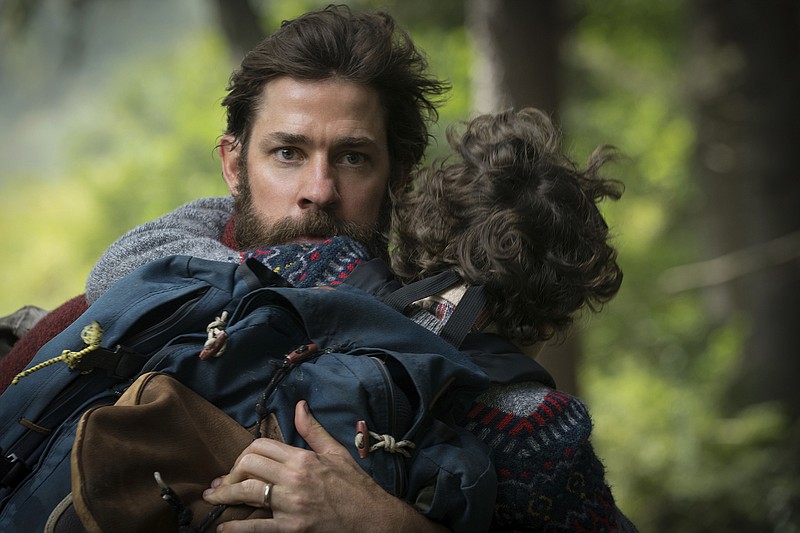 This image released by Paramount Pictures shows actor-director John Krasinski on the set of "A Quiet Place," with Noah Jupe. (Jonny Cournoyer/Paramount Pictures via AP)