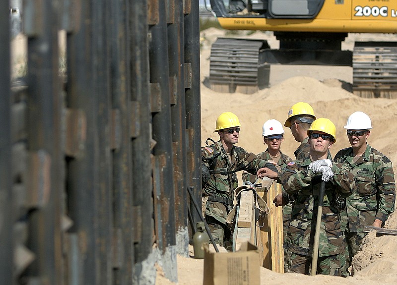 In this Monday, June 5, 2006, file photo, Utah National Guard troops from the 116th Construction Equipment Support Company, the first National Guard unit along the border as part of Operation Jump Start, prepare to extend a wall along the U.S.-Mexico border in San Luis, Ariz. In 2018, the U.S. National Guard faces a vastly different environment than it did on its last two deployments to the border with Mexico, with far fewer illegal crossings and more Central Americans than Mexicans coming. (AP Photo/Khampha Bouaphanh, File)