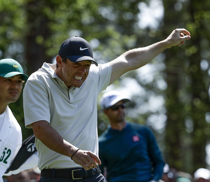 Rory McIlroy, of Northern Ireland, reacts to a shot by Adam Scott, of Australia, on the fourth hole during the second round at the Masters golf tournament Friday, April 6, 2018, in Augusta, Ga. (AP Photo/Chris Carlson)

