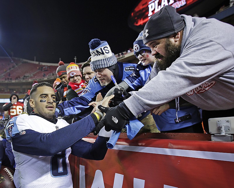 Tennessee Titans quarterback Marcus Mariota celebrates with fans after the team's NFL wild-card playoff football game against the Kansas City Chiefs on Saturday, Jan. 6, 2018, in Kansas City, Mo. The Titans won 22-21. (AP Photo/Charlie Riedel)