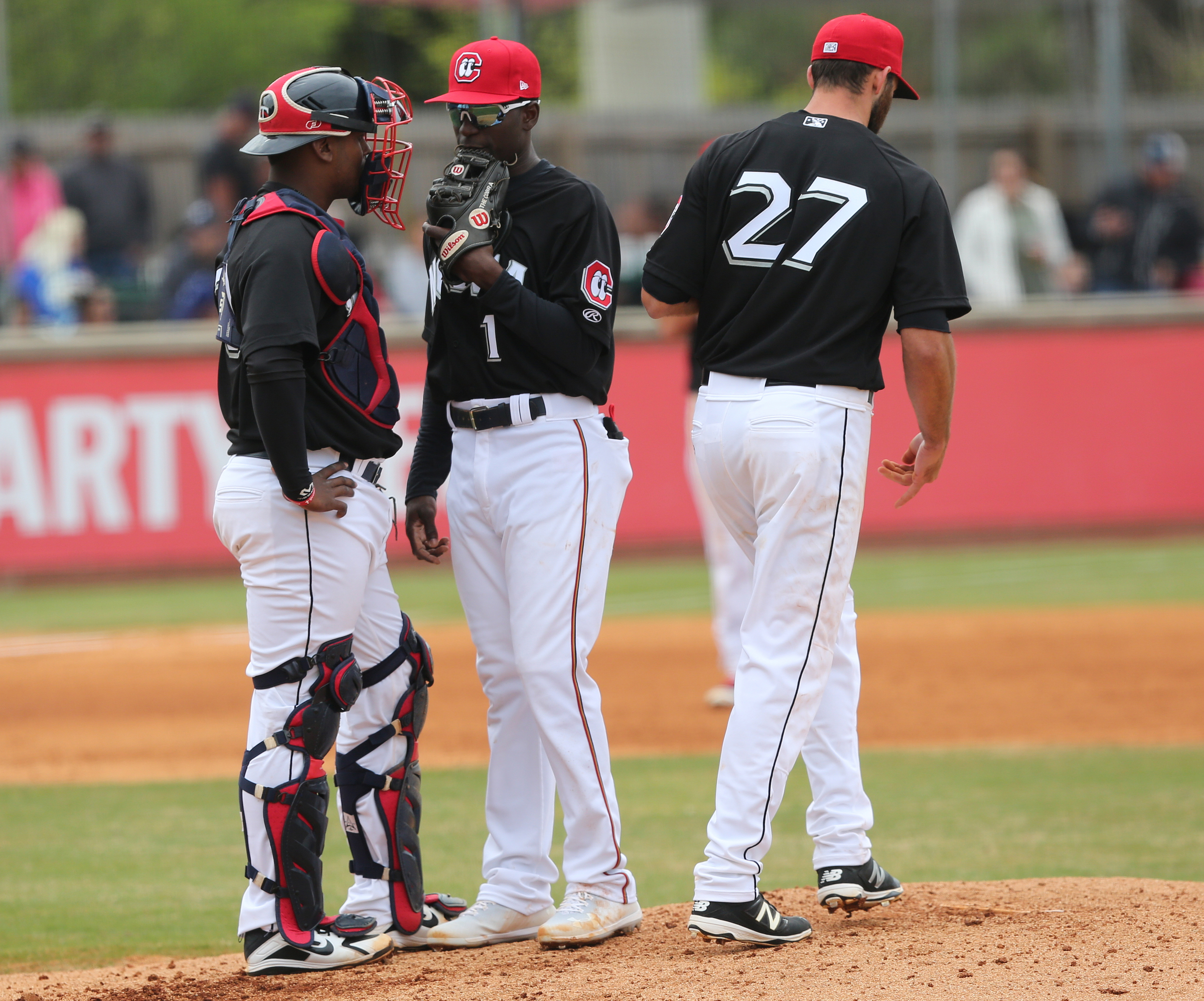 Chattanooga Lookouts catcher Brian Navarreto (20) speaks with shortstop Nick Gordon (1) and pitcher Randy LeBlanc (27) Sunday, April 8, 2018 during the Lookouts game against the Barons at AT&T Field in Chattanooga, Tenn.