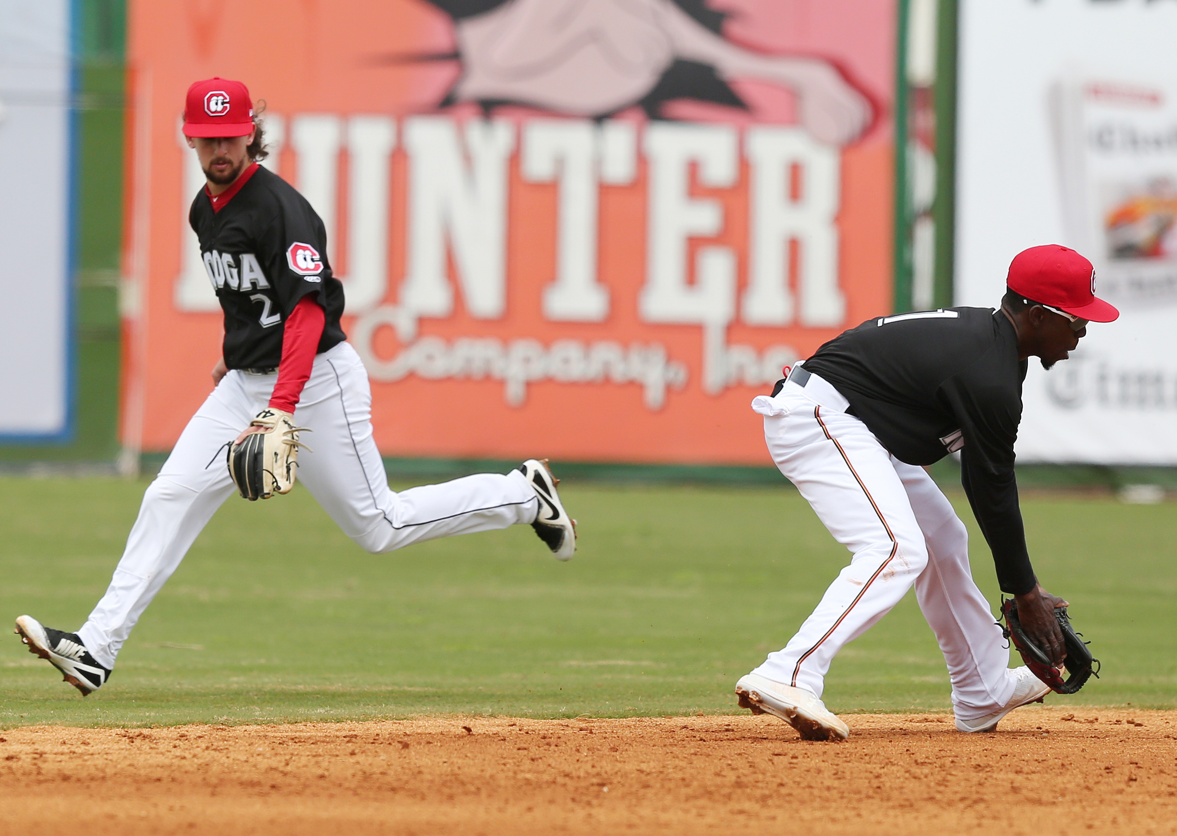 Chattanooga Lookouts second baseman Sean Miller, left, backs up shortstop Nick Gordon as he fields a grounder during a game against the Birmingham Barons on Sunday at AT&T Field. The Barons swept the afternoon doubleheader, 4-0 and 4-2, to clinch a series victory.