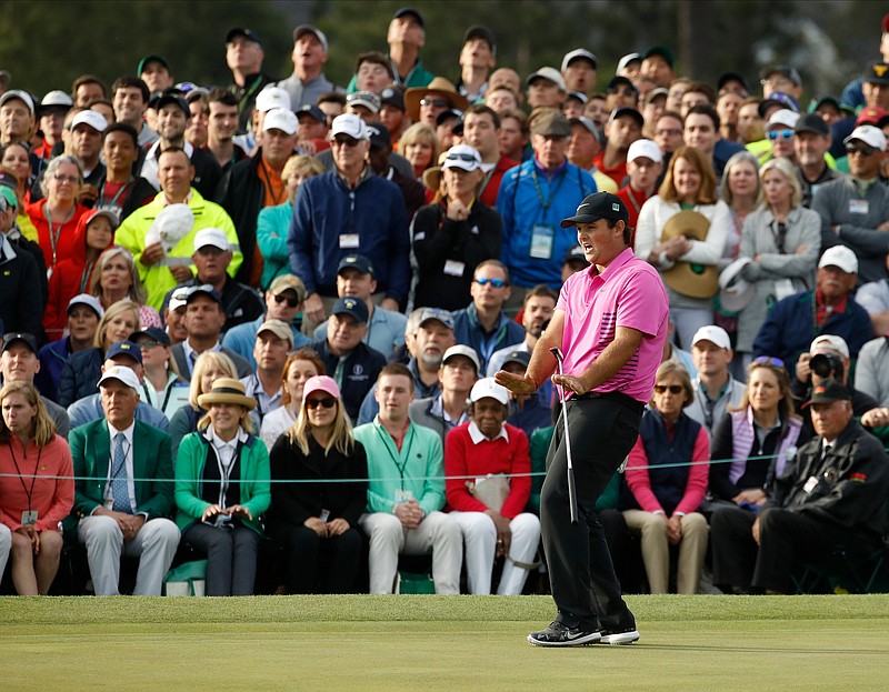 Patrick Reed reacts to a putt on the 18th hole during the fourth round at the Masters golf tournament Sunday, April 8, 2018, in Augusta, Ga. (AP Photo/Charlie Riedel)