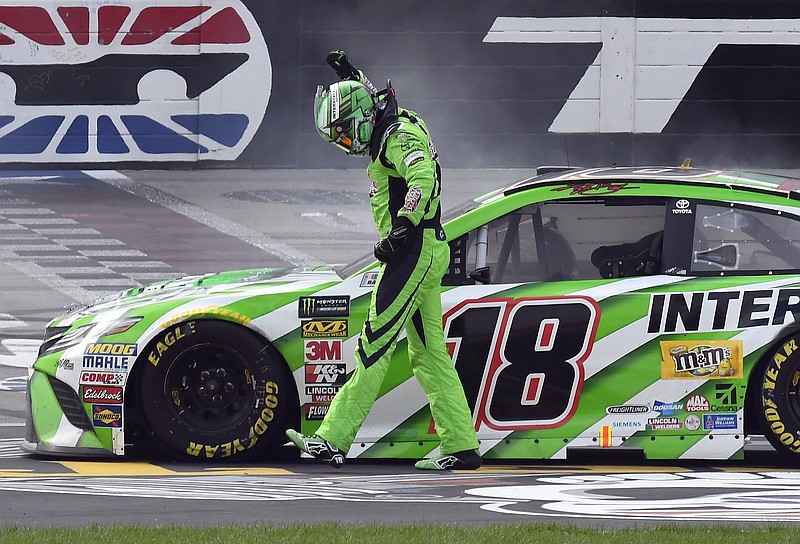 Kyle Busch (18) celebrates after winning a NASCAR Cup Series auto race in Fort Worth, Texas, Sunday, April 8, 2018. (AP Photo/Larry Papke)