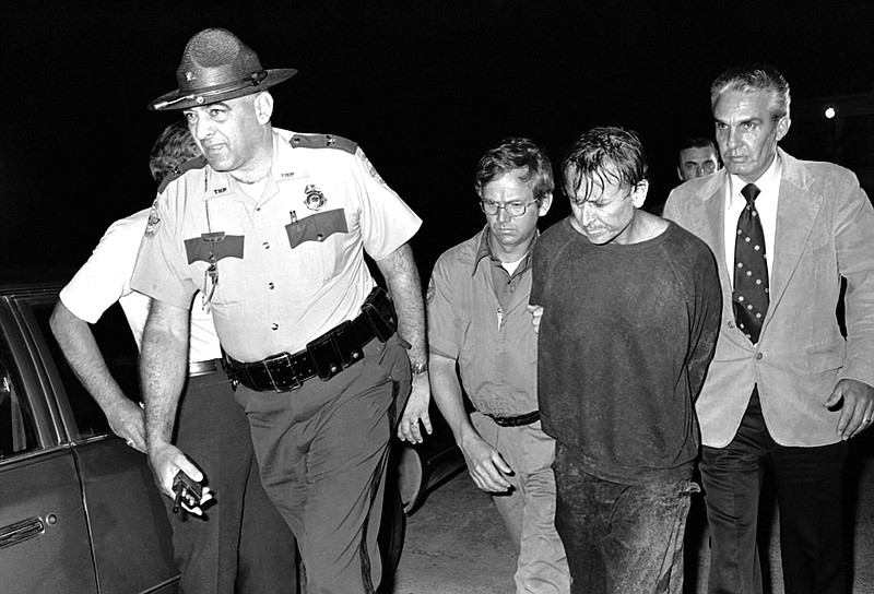 James Earl Ray, right, is escorted by Brushy Mountain State Prison Warden Stonney Lane following Ray's capture in the rugged country near Petros, Tenn., on June 13, 1977. (The Associated Press file photo)
