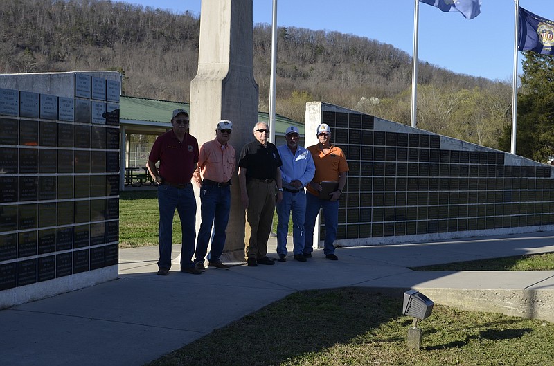 Wall of Honor board members Robert Cothran, Raymond Kerns, Geno Shipley and Jim Penny, from left, stand in front of the monument at Veterans Park in Soddy-Daisy. Not pictured is board member Sara Burris. (Staff photo by Emily Crisman)