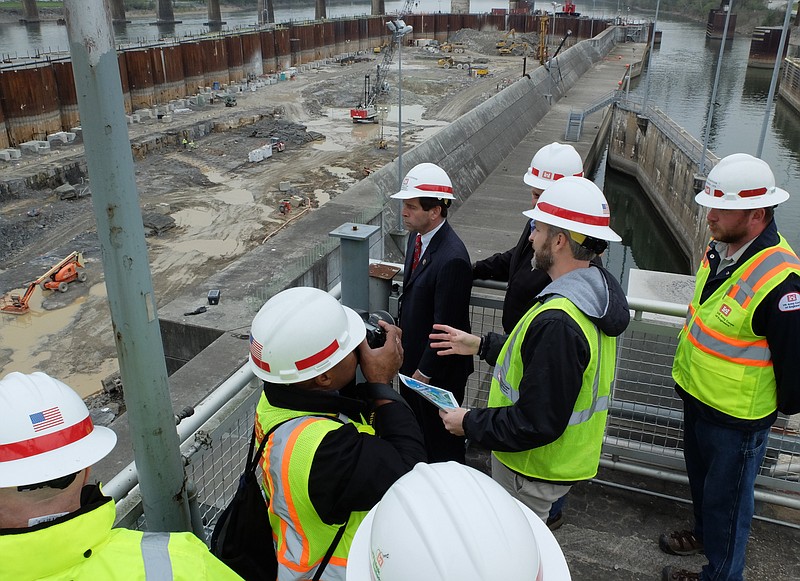 Congressman Chuck Fleishman, center, and US Corps of Engineers representative talk about the Chickamauga Lock project Monday as Heeter Geo Technical Construction crews work to remove 100,000 cubic yards of mostly limestone rock for the lock.
