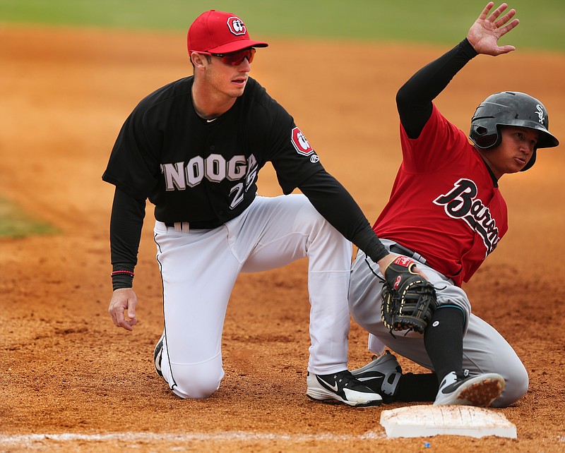 Chattanooga Lookouts first baseman Brent Rooker tags Birmingham's Bryant Flete on a pickoff attempt during Sunday's game at AT&T Field.