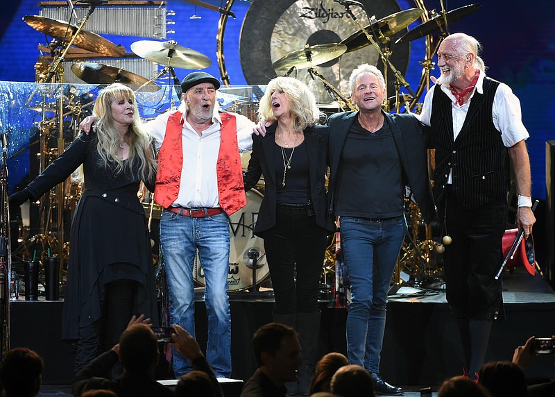 FILe - In this Jan. 26, 2018 file photo, Fleetwood Mac band members, from left, Stevie Nicks, John McVie, Christine McVie, Lindsey Buckingham and Mick Fleetwood appear at the 2018 MusiCares Person of the Year tribute honoring Fleetwood Mac in New York. The band said in a statement Monday that Buckingham is out of the band for its upcoming tour. Buckingham left the group once before, from 1987 to 1996.  He’ll be jointly replaced by Neil Finn of Crowded House and Mike Campbell of Tom Petty and the Heartbreakers. (Photo by Evan Agostini/Invision/AP, File)