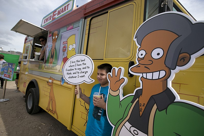 In this March 15, 2015 file photo, Migael Pimentel, 9, holds up an Apu saying as he has his photo taken at the Simpsons Kwik-E-Mart Truck at South Bites Food during SXSW at the Austin Convention Center in Austin, Texas. "The Simpsons" briefly addressed Sunday, April 8, 2018, criticism of its portrayal of its Indian shop owner, Apu. But a comedian who helped spark a conversation about the character calls the show's response "sad" and attacked the show on Twitter for reducing a discussion about racism to political correctness. (Deborah Cannon/Austin American-Statesman via AP, File)