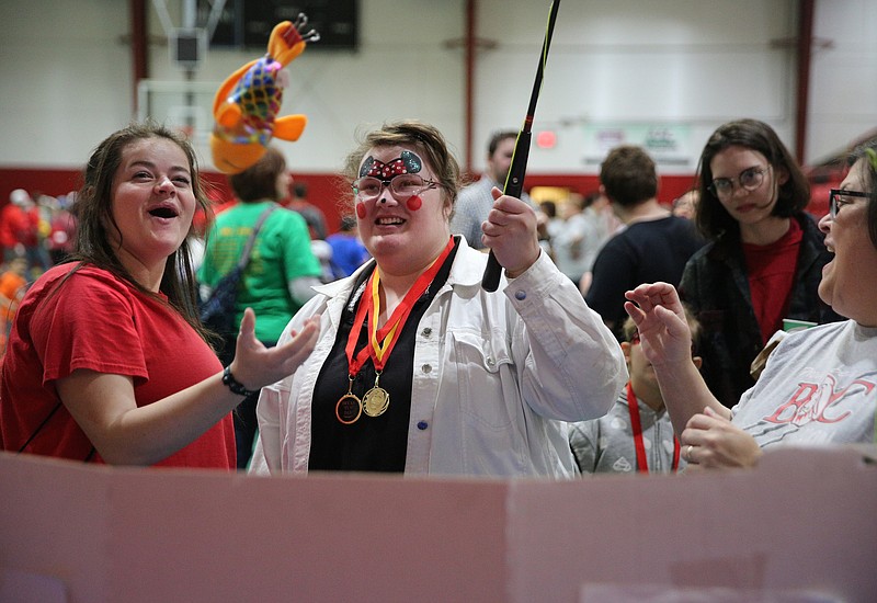 Anna Sanders, a sophomore exercise and heath science major at Bryan College, celebrates with Kayla Barker, an 11th grader at Rhea County High School, as she pulls a fish up with a fishing pole during the All-College Service Day Luke 14 Fun Day on the Hill event Tuesday, April 10, 2018 at Bryan College in Dayton, Tenn. Bryan College hosted a Luke 14 Day on the Hill event, in which education majors and athletes invited 90 Rhea County school students with mental or physical disabilities to come to campus for a fun day of outdoor games, carnival booths and a special lunch picnic.