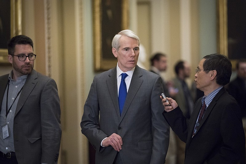 Sen. Rob Portman, R-Ohio, talks to reporters after a policy luncheon on Capitol Hill in Washington last month. President Trump was to sign legislation co-authored by Portman that strengthens the policing of sex trafficking, over the opposition of many internet companies.